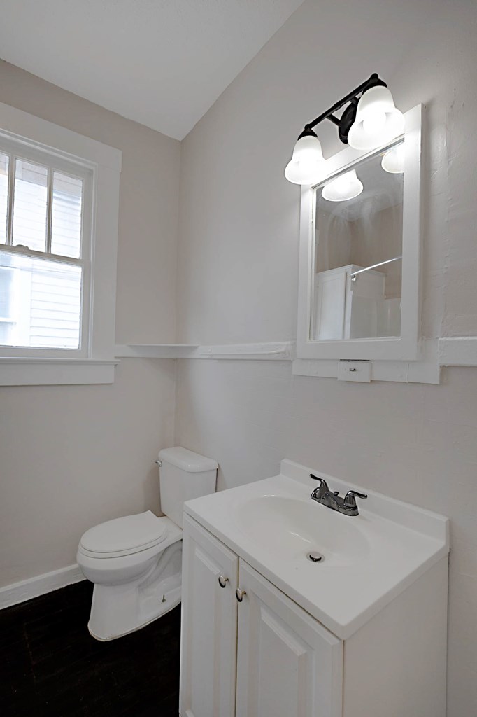 1037 30th Street Columbus, GA 31904 - Photo 11 of 16 a bathroom with a sink a toilet and mirror