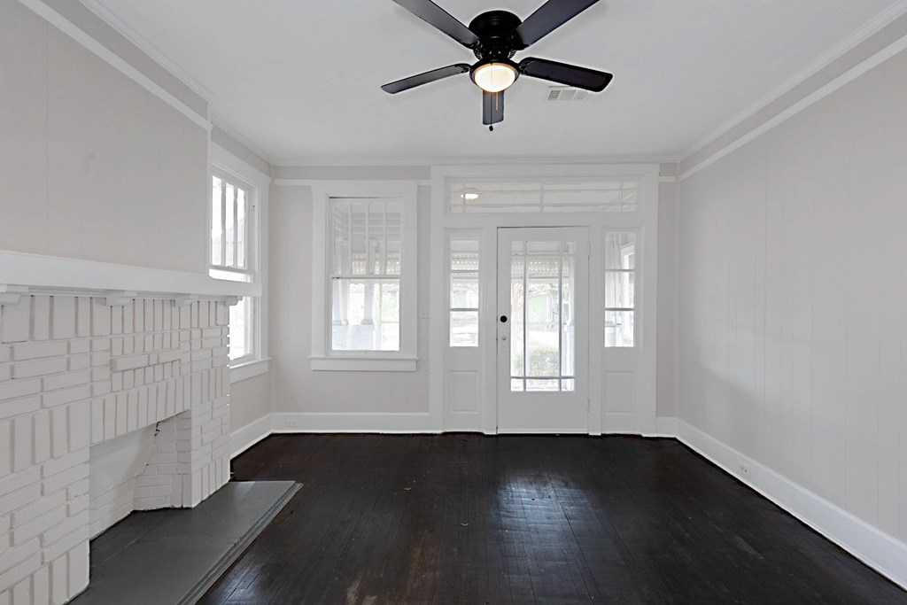1037 30th Street Columbus, GA 31904 - Photo 3 of 16 a view of an empty room with wooden floor and a window