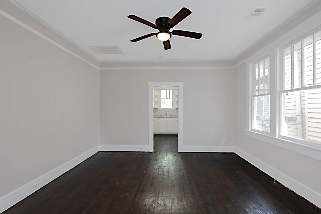 1037 30th Street Columbus, GA 31904 - Photo 5 of 16 a view of empty room with wooden floor and fan