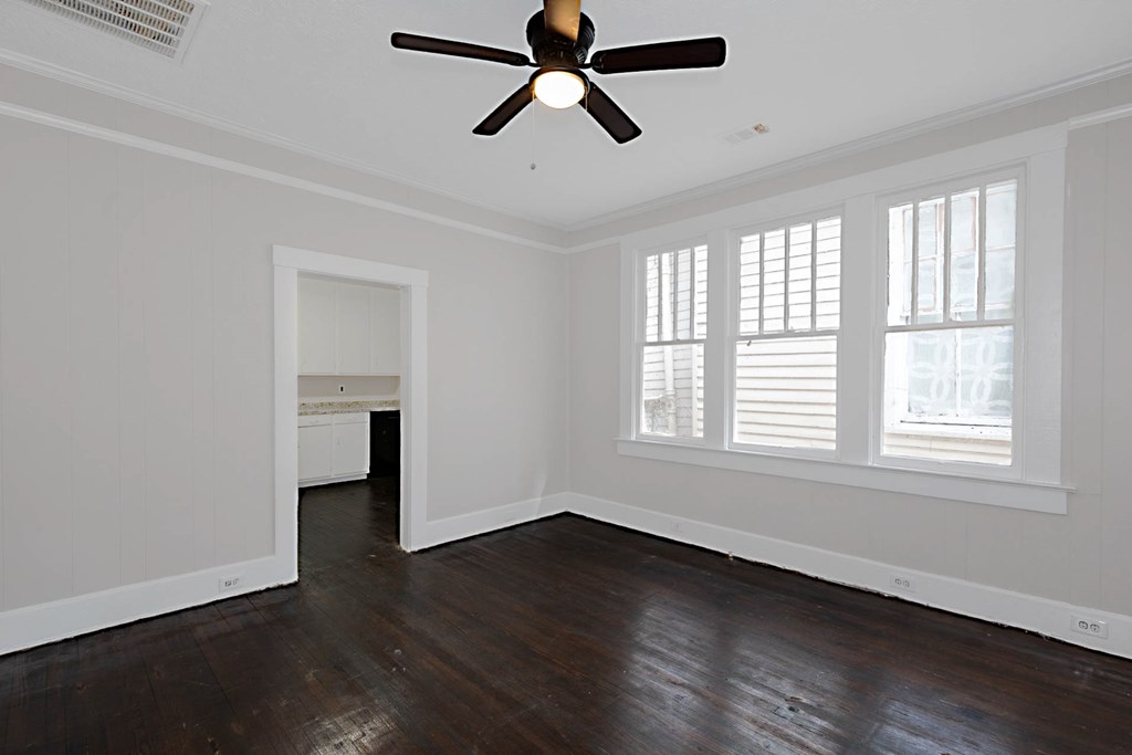 1037 30th Street Columbus, GA 31904 - Photo 6 of 16 a view of empty room with wooden floor and fan