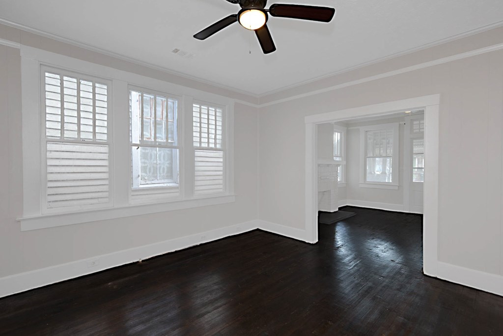 1037 30th Street Columbus, GA 31904 - Photo 7 of 16 a view of an empty room with wooden floor and a window