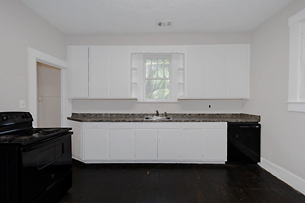 1037 30th Street Columbus, GA 31904 - Photo 8 of 16 a kitchen with a refrigerator and a stove top oven