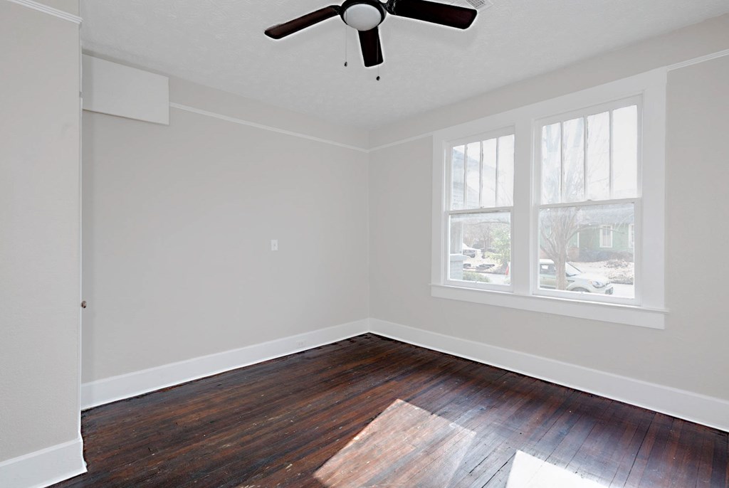 1037 30th Street Columbus, GA 31904 - Photo 10 of 16 wooden floor in an empty room with a window