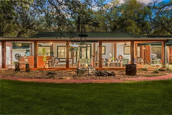 a view of a house with backyard porch and sitting area