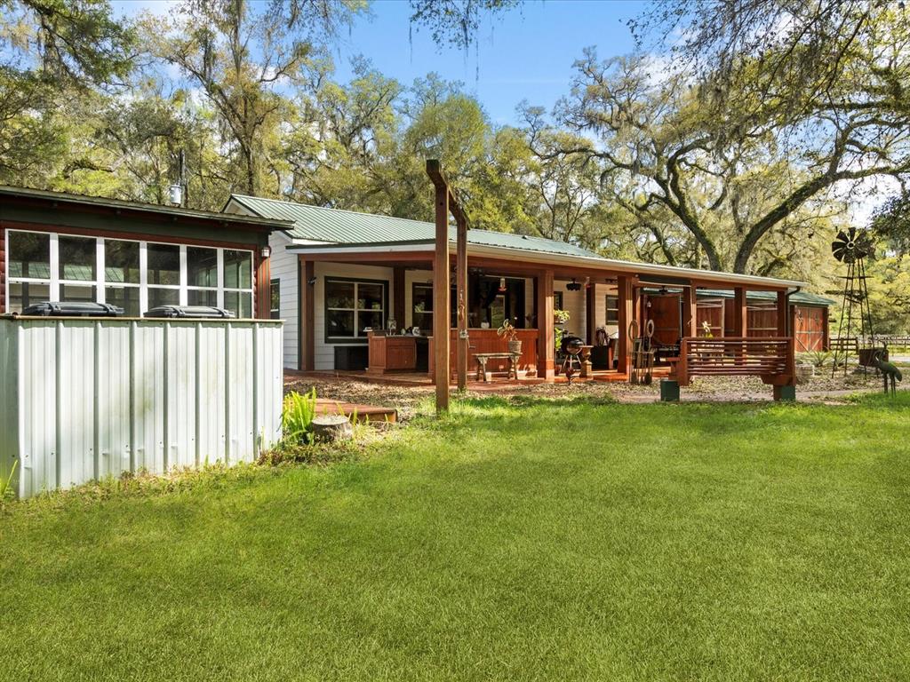 10820 Southwest 31st Way Webster, FL 33597 - Photo 11 of 37 a front view of a house with a garden and porch