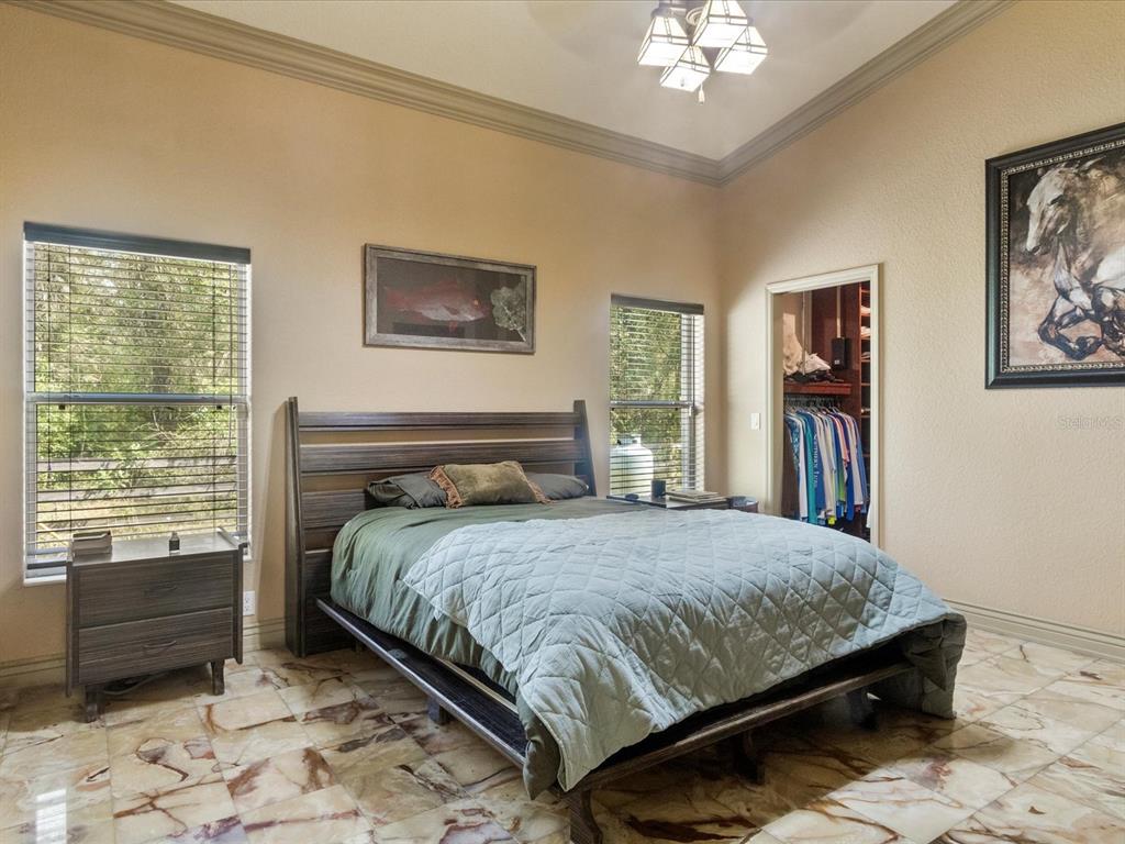 10820 Southwest 31st Way Webster, FL 33597 - Photo 28 of 37 a bedroom with a bed a dresser and a window