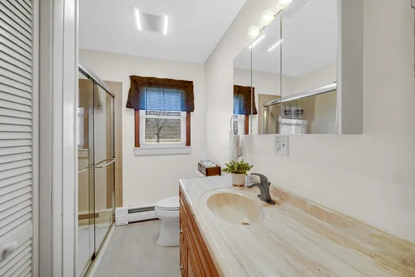a bathroom with a tub sink and mirror