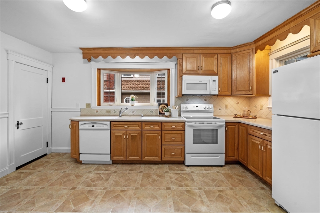 33 Intervale Avenue Saugus, MA 01906 - Photo 14 of 40 a kitchen with stainless steel appliances granite countertop a stove a sink and a refrigerator