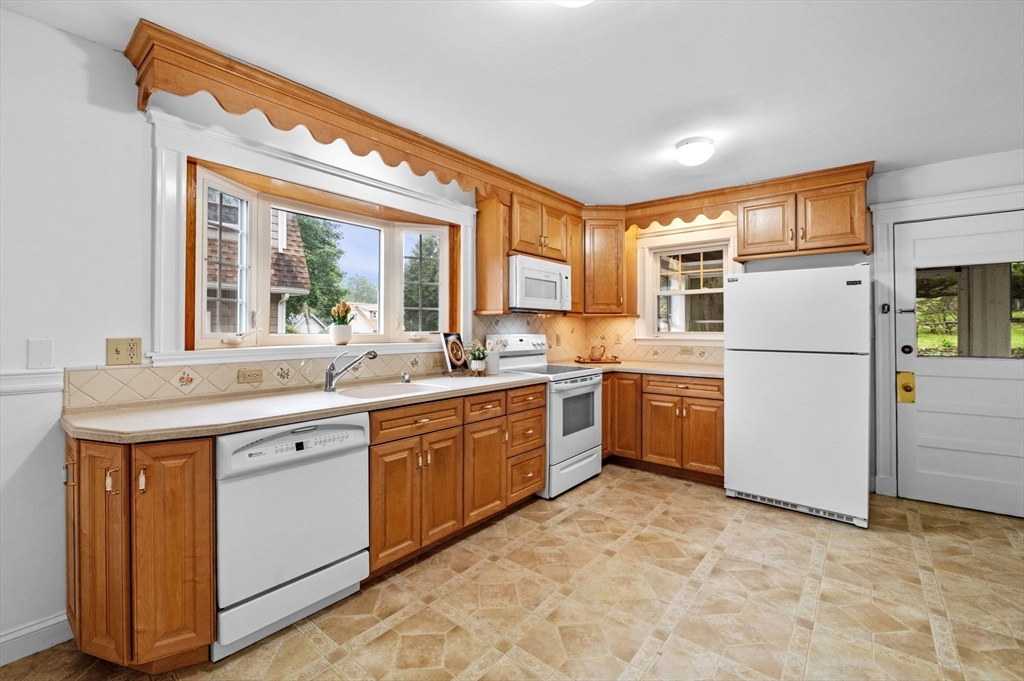 33 Intervale Avenue Saugus, MA 01906 - Photo 15 of 40 a kitchen with a sink refrigerator and cabinets