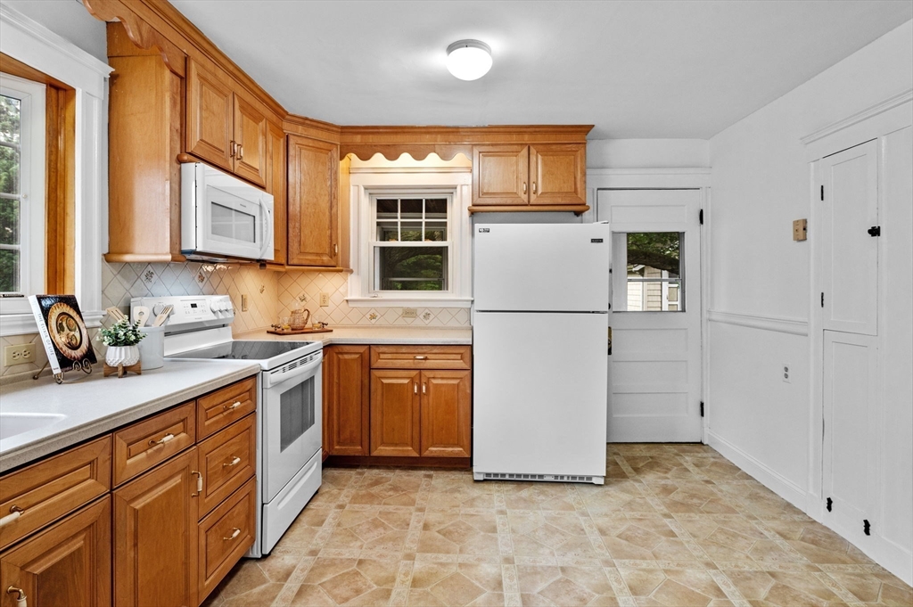 33 Intervale Avenue Saugus, MA 01906 - Photo 16 of 40 a kitchen with stainless steel appliances granite countertop a refrigerator sink and stove