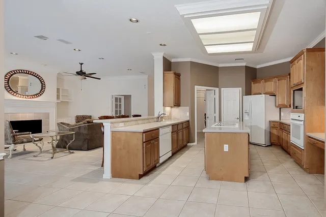 a kitchen with furniture a counter top space and stainless steel appliances