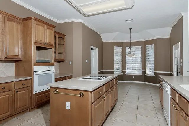 a kitchen with granite countertop a sink stove and refrigerator