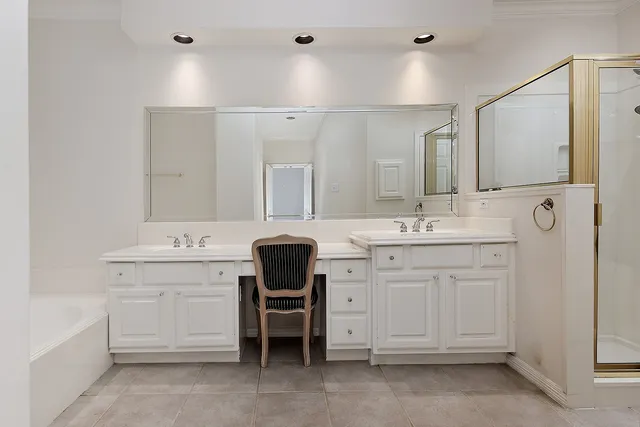 a spacious bathroom with a sink vanity and mirror
