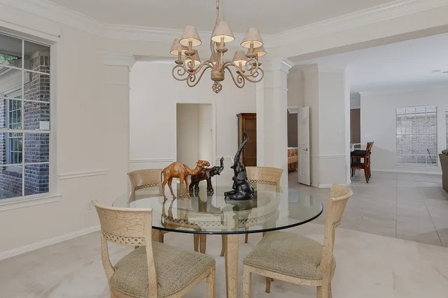 a dining room with furniture and chandelier