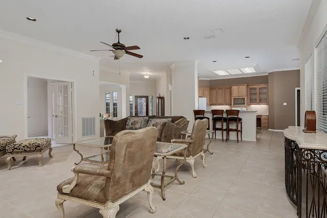 a living room with furniture and a dining table