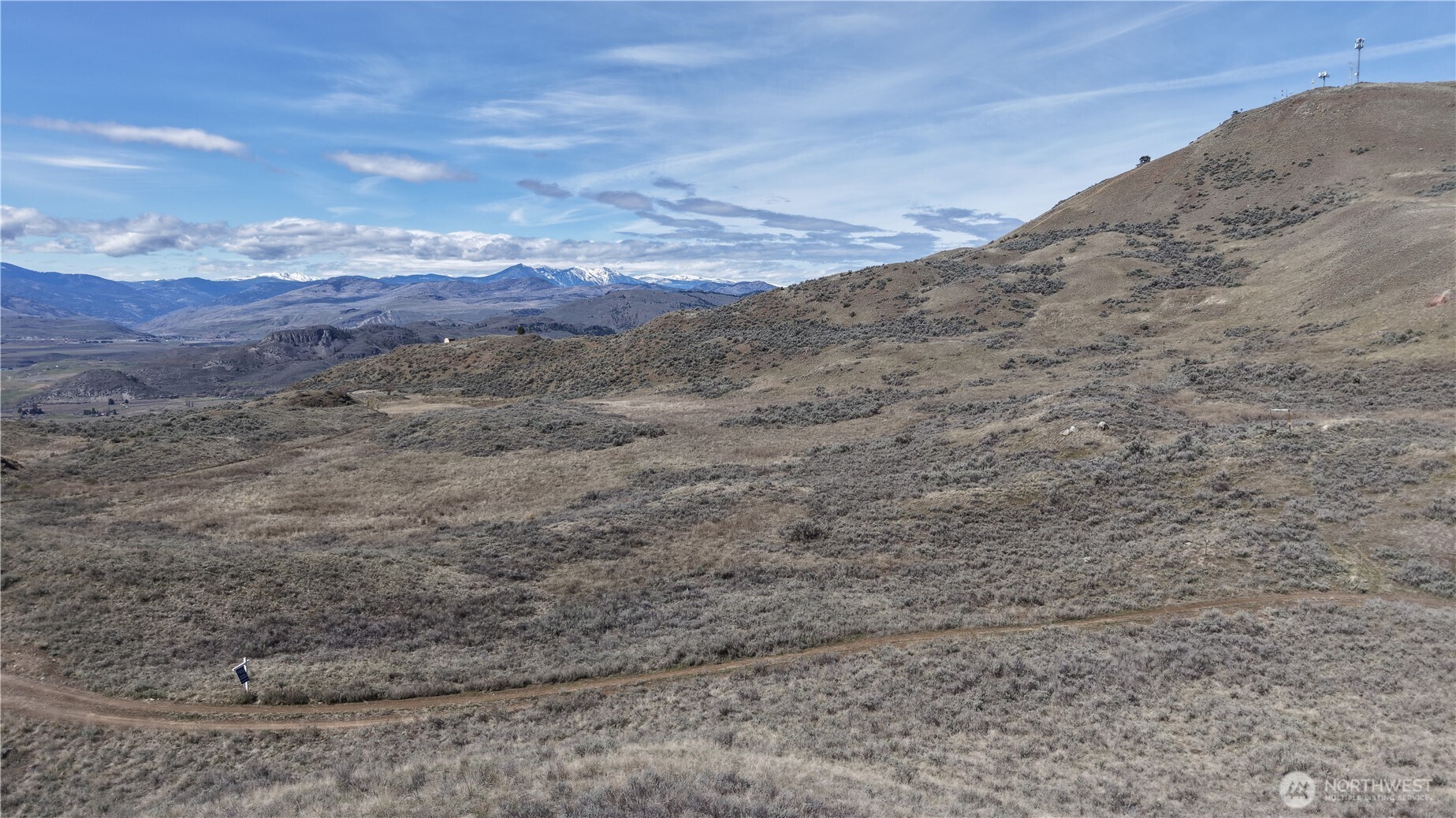-xxx Emily Road Tonasket, WA 98855 - Photo 31 of 31 a view of a dry yard with mountains in the background