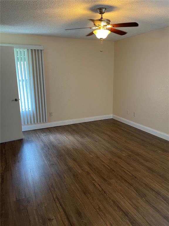 5144 Conroy Road, Unit 32 Orlando, FL 32811 - Photo 13 of 16 a view of empty room with wooden floor and fan