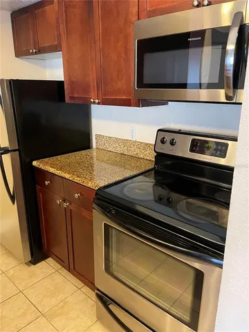 a stove top oven sitting inside of a kitchen