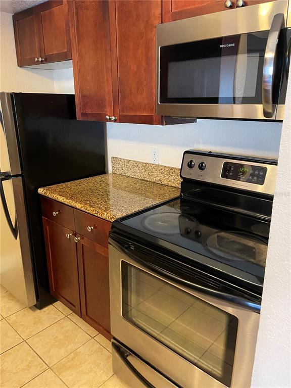5144 Conroy Road, Unit 32 Orlando, FL 32811 - Photo 4 of 16 a stove top oven sitting inside of a kitchen