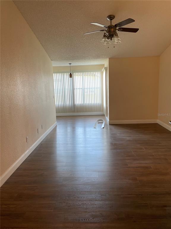 5144 Conroy Road, Unit 32 Orlando, FL 32811 - Photo 6 of 16 a view of an empty room with a window and wooden floor