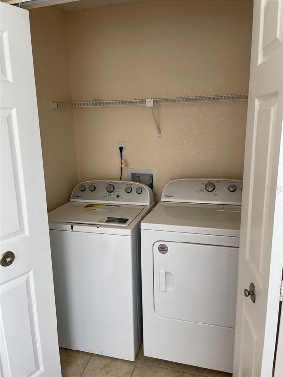 5144 Conroy Road, Unit 32 Orlando, FL 32811 - Photo 8 of 16 a utility room with dryer and washer