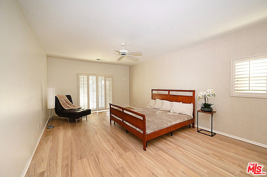 699 Alta Ridge Palm Springs, CA 92262 - Photo 11 of 31 a living room with a bed furniture and a wooden floor