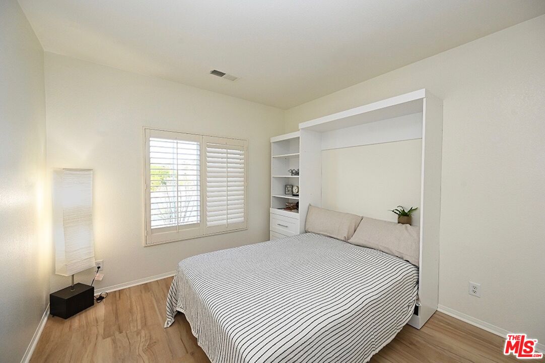 699 Alta Ridge Palm Springs, CA 92262 - Photo 18 of 31 a bedroom with a bed and a window