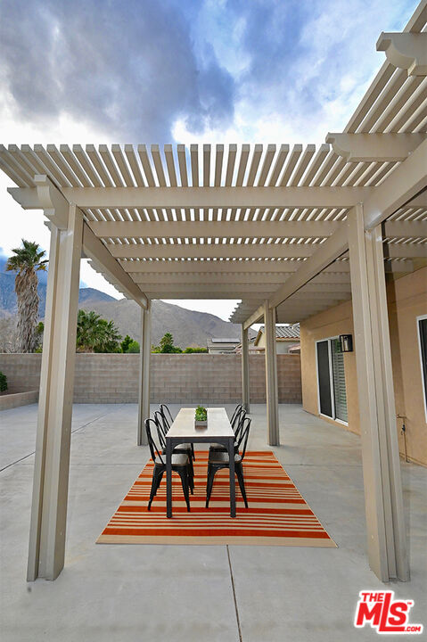 699 Alta Ridge Palm Springs, CA 92262 - Photo 20 of 31 a view of a chairs and table in a patio