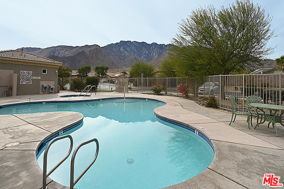 699 Alta Ridge Palm Springs, CA 92262 - Photo 26 of 31 a view of a swimming pool with a patio and a garden