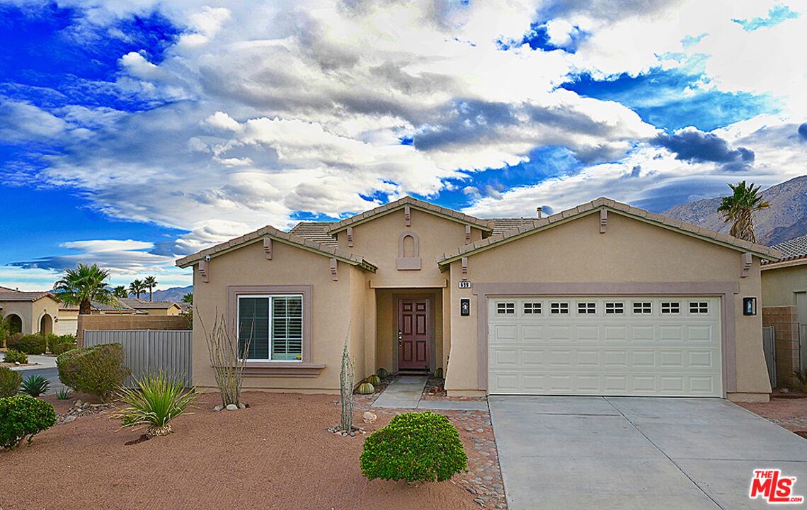 699 Alta Ridge Palm Springs, CA 92262 - Photo 5 of 31 a view of a house with small yard plants and a large tree