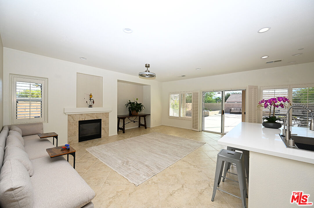 699 Alta Ridge Palm Springs, CA 92262 - Photo 7 of 31 a living room with furniture a fireplace and a flat screen tv