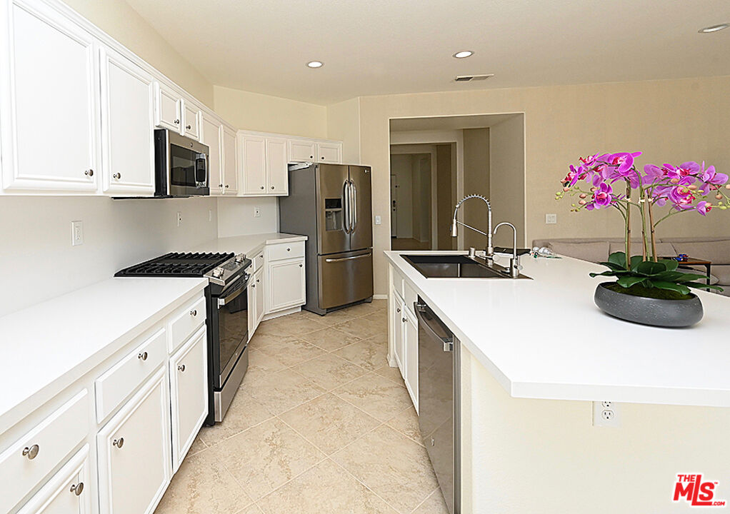 699 Alta Ridge Palm Springs, CA 92262 - Photo 9 of 31 a kitchen with a sink stove and refrigerator