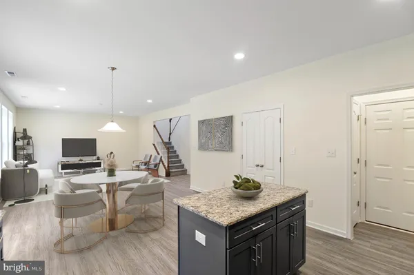 a kitchen with stainless steel appliances granite countertop a sink stove and wooden floor