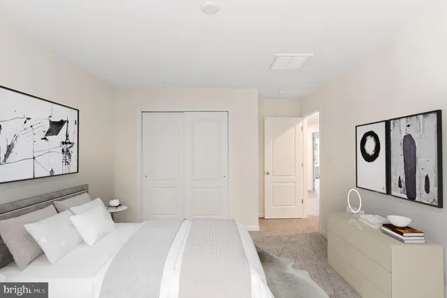 a bedroom with a bed and cabinets