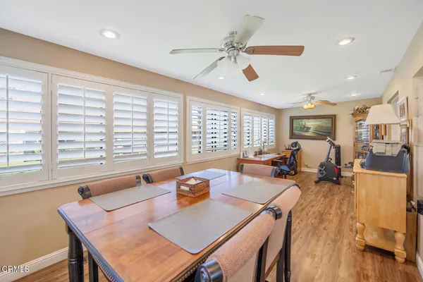 a view of a dining room with furniture and wooden floor