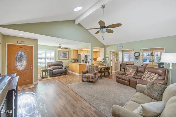 a living room with furniture a ceiling fan and a window