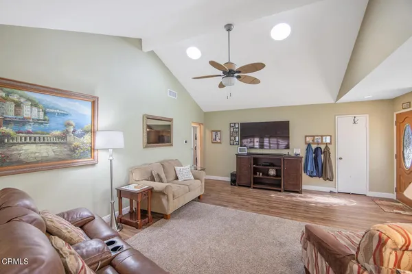 a living room with furniture a fireplace and a flat screen tv