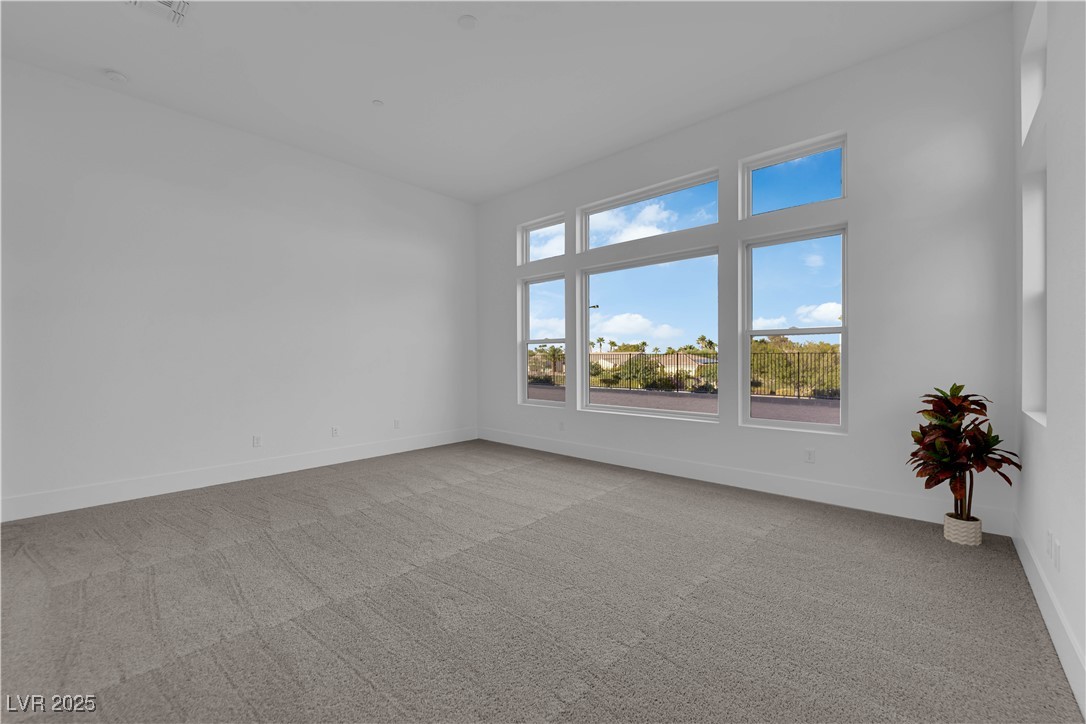 4792 Outlook Peak Street Las Vegas, NV 89135 - Photo 22 of 56 Empty room featuring light carpet