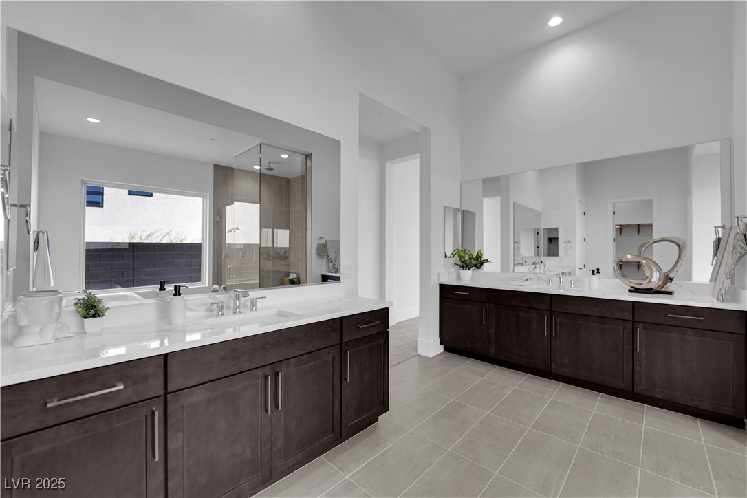 4792 Outlook Peak Street Las Vegas, NV 89135 - Photo 26 of 56 Full bathroom featuring two vanities, walk in shower, light tile patterned floors, and recessed lighting
