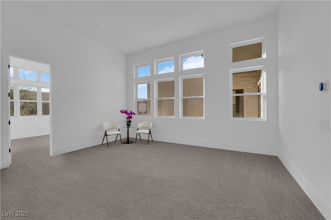 4792 Outlook Peak Street Las Vegas, NV 89135 - Photo 31 of 56 Spare room featuring light colored carpet and baseboards