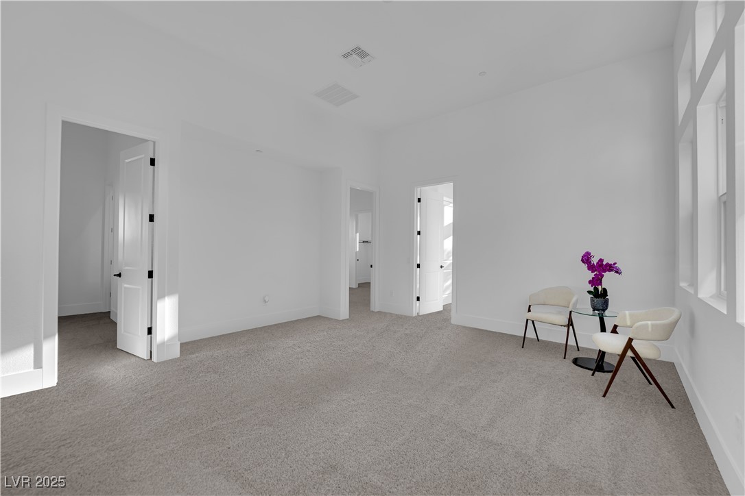 4792 Outlook Peak Street Las Vegas, NV 89135 - Photo 32 of 56 Unfurnished bedroom with light colored carpet and ensuite bath