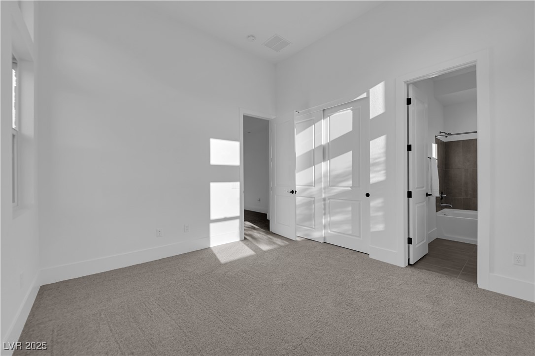 4792 Outlook Peak Street Las Vegas, NV 89135 - Photo 35 of 56 Unfurnished bedroom featuring light carpet and ensuite bathroom