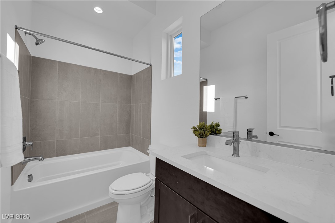 4792 Outlook Peak Street Las Vegas, NV 89135 - Photo 36 of 56 Bathroom with shower / tub combination, vanity, light tile patterned flooring, and recessed lighting