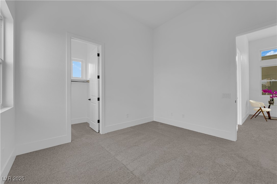 4792 Outlook Peak Street Las Vegas, NV 89135 - Photo 39 of 56 Spare room featuring light carpet and baseboards