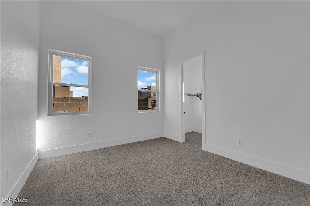 4792 Outlook Peak Street Las Vegas, NV 89135 - Photo 40 of 56 Carpeted spare room with baseboards