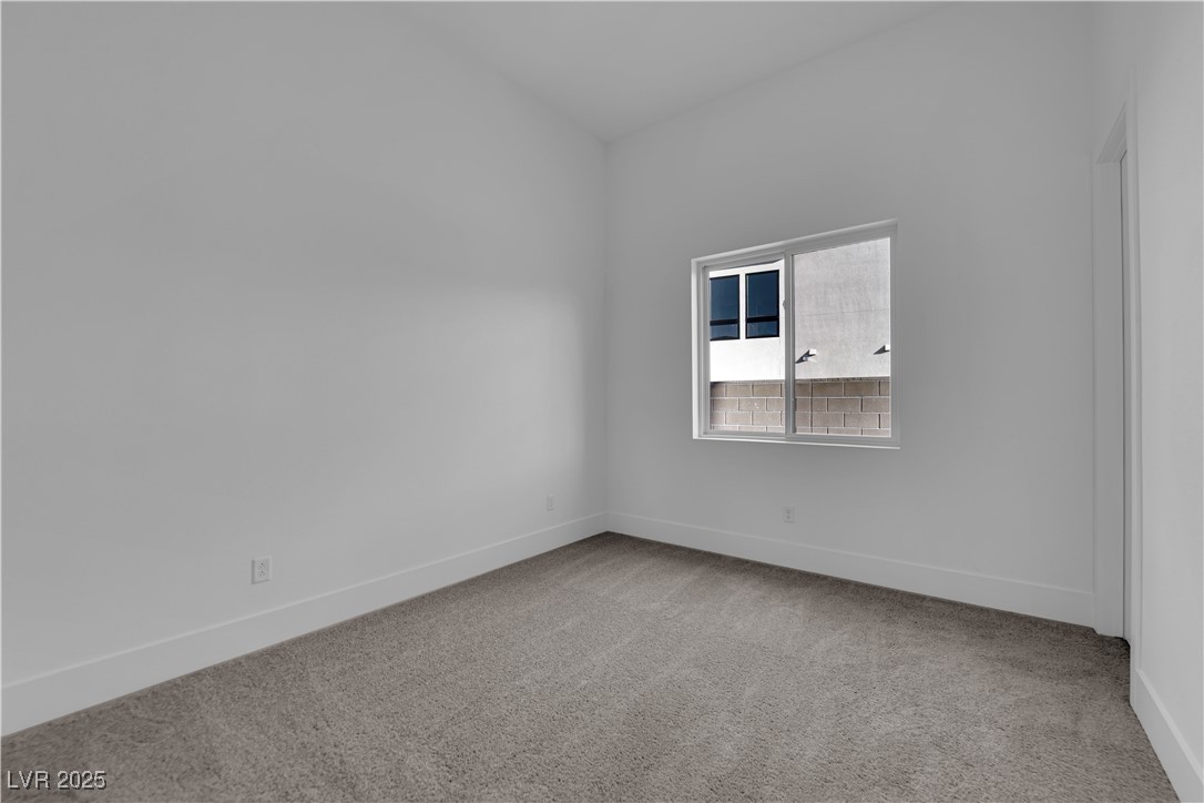 4792 Outlook Peak Street Las Vegas, NV 89135 - Photo 41 of 56 Unfurnished room with light carpet and baseboards