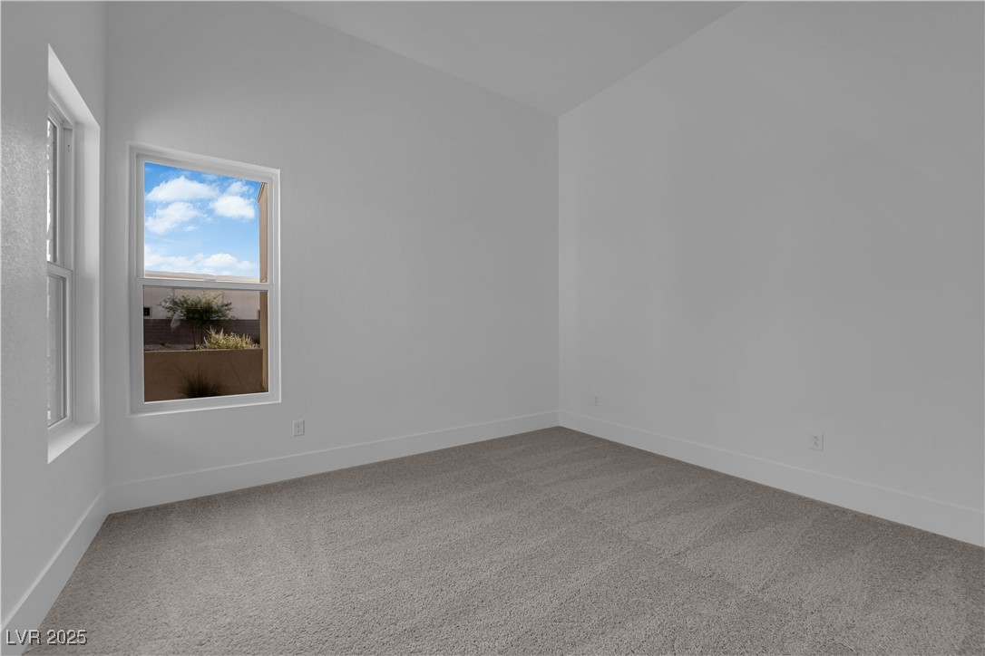 4792 Outlook Peak Street Las Vegas, NV 89135 - Photo 45 of 56 Spare room featuring light carpet and baseboards