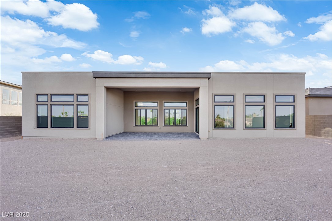 4792 Outlook Peak Street Las Vegas, NV 89135 - Photo 50 of 56 Back of property featuring stucco siding and a patio