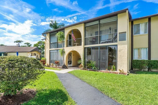 a front view of a house with a yard table and chairs