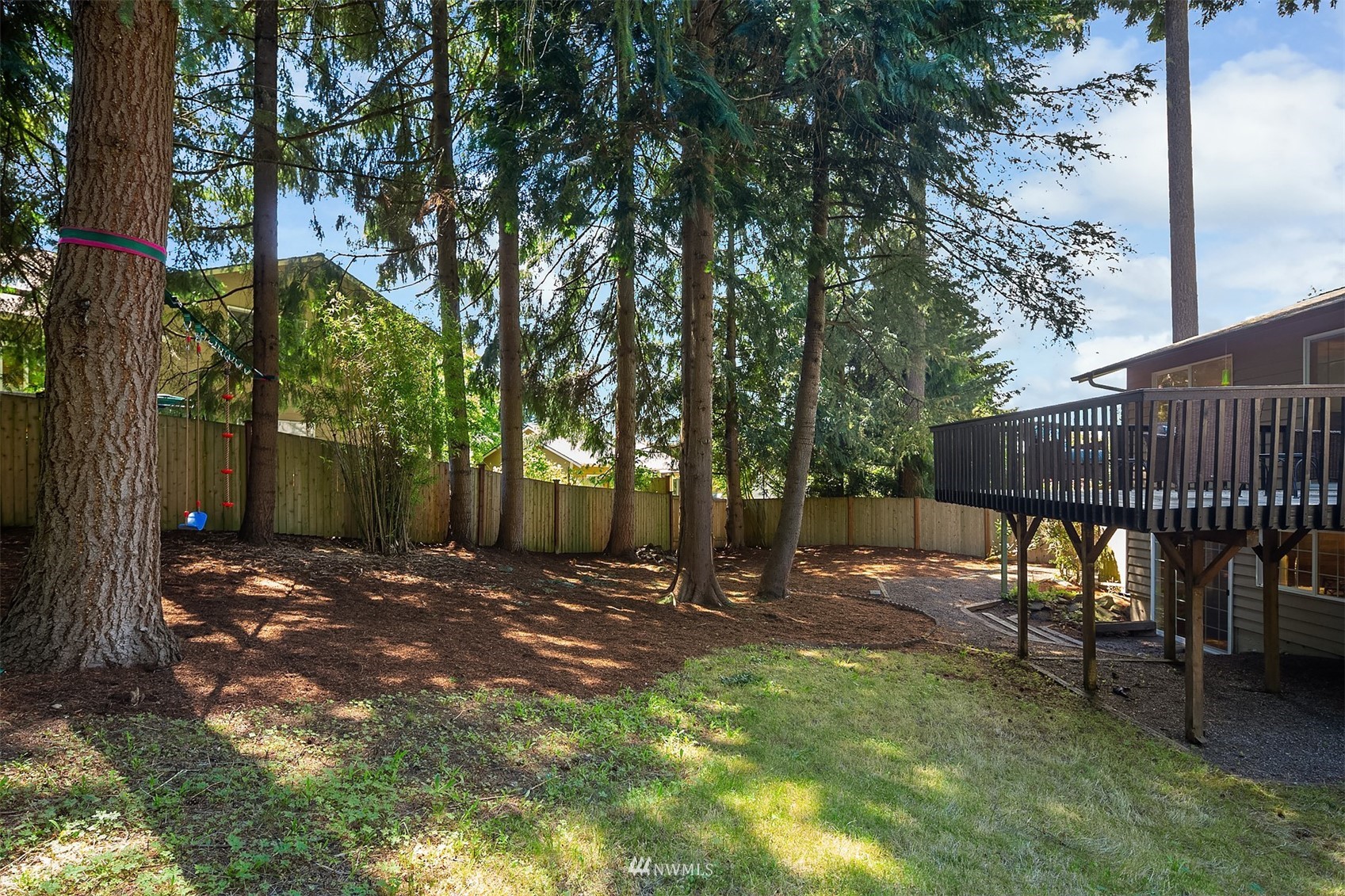 3310 199th Place Southeast Bothell, WA 98012 - Photo 26 of 30 a view of a backyard with wooden fence and a large tree